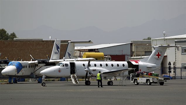  Yemeni workers unload an aircraft of the International Committee of the Red Cross (ICRC) upon its arrival at Sanaa’s International Airport on August 16, 2016 after the airport reopened to air flights of the United Nations and other international humanitarian organisations. 