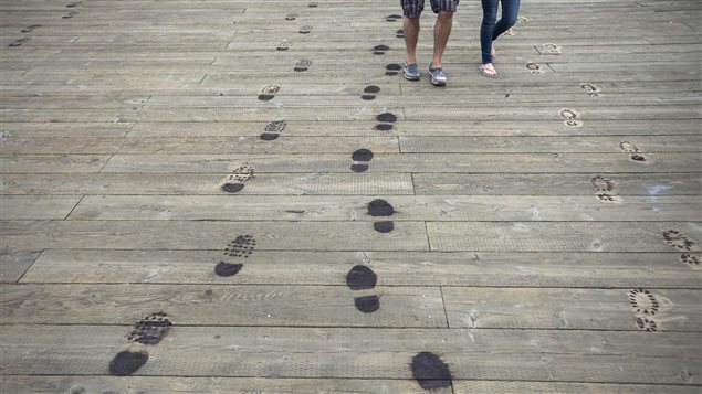 Footprints burned into the boardwalk symbolize the last steps thousands of Canadian soldiers took on home soil.