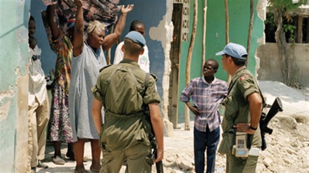 May 8, 1997, Port-au-Prince: UN peacekeepers from the Canadian Battalion, part of the United Nations Support Mission in Haiti (UNSMIH), talking with an upset Port-au-Prince woman. Peacekeeping now requires a much wider skill set of members beyond military tactics.