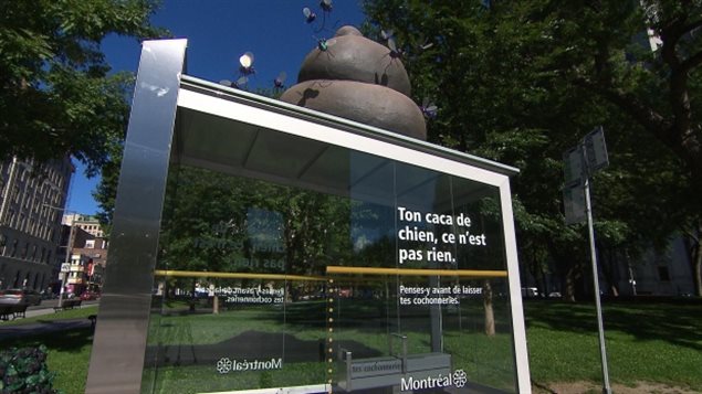 Part of Montreal's anti-litter campaign (above) is causing a bit of kerfuffle. We see an empty bus stop shelter. Atop sits a large poo (possibly four feet by three feet-hard to tell from pic.) Surrounding it are plastic flies, whose size would put your average horse fly to shame. On the front of the shelter is written, "Ton caca de chien, ce ne pas rien."