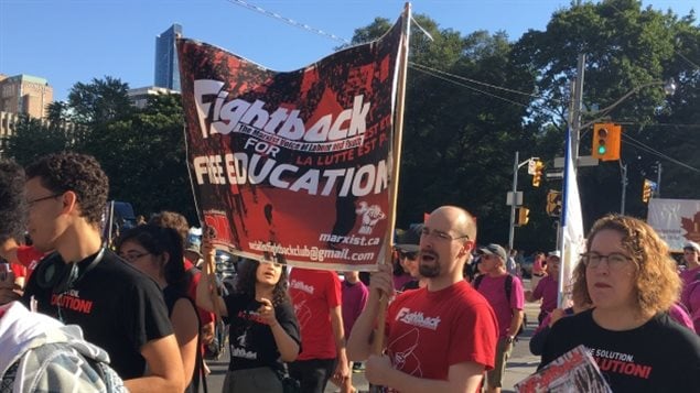 Some marchers in the Toronto Labour Day parade focus on issues like free education.
