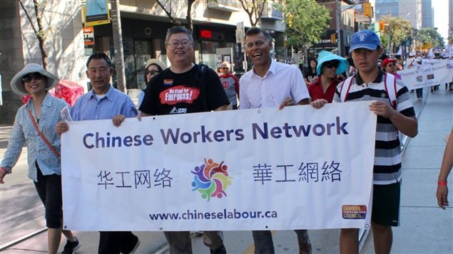 Canadian Labour Congress president Hassan Yussuff (second from right) marches with workers in Toronto to celebrate Labour Day on Sept. 5, 2016.
