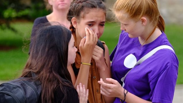 Teenage girls attend a rally in Woodstock, Ontario in July 2016 after five young people took their lives over a four-month period.
