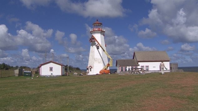 Repainting of the *Confederation Lighthouse* is going on now and should take about two weeks, althoughl the winds are slowing things downs.