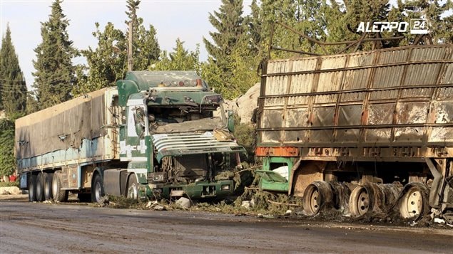  This image provided by the Syrian anti-government group Aleppo 24 news, shows damaged trucks carrying aid, in Aleppo, Syria, Tuesday, Sept. 20, 2016. A U.N. humanitarian aid convoy in Syria was attacked Monday as the Syrian military declared that a U.S.-Russian brokered cease-fire had failed, and U.N. officials reported many dead and seriously wounded. (Aleppo 24 news via AP)