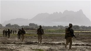 Canadian soldiers from 4th platoon, B company 1st Battalion, Royal 22nd Regiment walk during a patrol in the Panjwai district of Kandahar province southern Afghanistan, June 16, 2011.