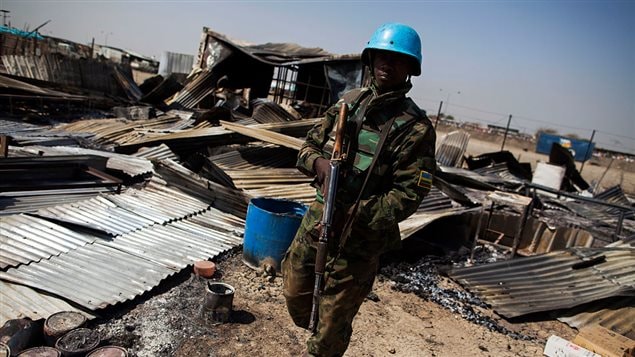  A UN peacekeeper from Rwanda walks through the remnants of a looted and burnt clinic in the UN Protection of Civilians (PoC) site in Malakal, on February 26, 2016.