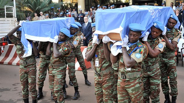  UN peacekeeping force soldiers carry coffins covered with United Nations flag at Bamako on february 17, 2016, at the last tribute to seven guinean UN soldiers killed on february 12 during a jihadist attack against their camp at Kidal.