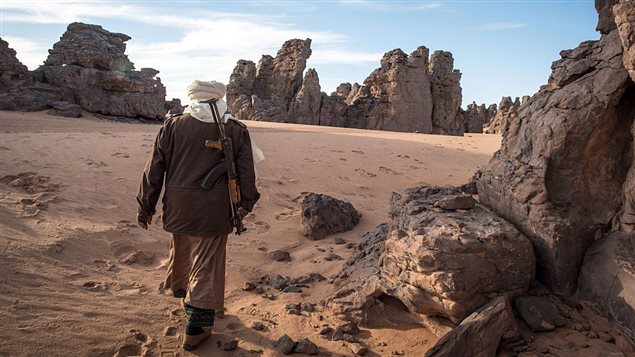  A Touareg tribesman walks in the Meggedat valley, north west of Libya’s Akakus mountain region, in the desert of the western Ghat District, on January 2, 2016.