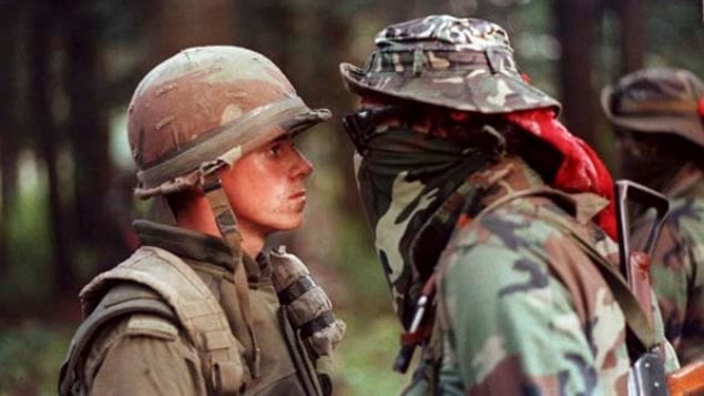 The most famous photo of the crisis, a Saskatchewan native, Brad Larocque, and Pte Patrick Cloutier. (the *warrior* is often mis-identified as Ronald *Lasagna* Cross, who later was charged and spent time in jail for his part in the crisis.