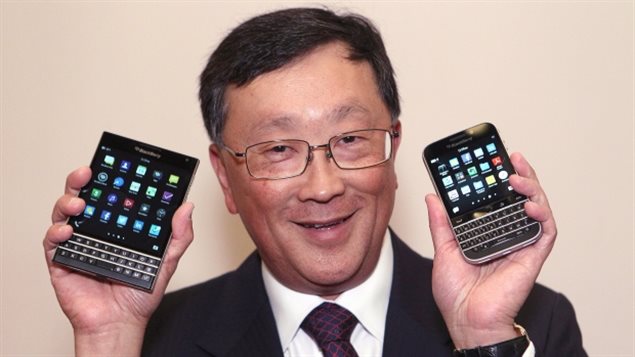 BlackBerry CEO John Chen shows off the Passport phone, left, and Classic phone models at the company’s annual general meeting in June.