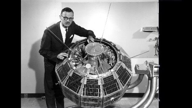 John Chapman Dr.John Chapman showing some of the internal electronics of Alouette-1 in 1962