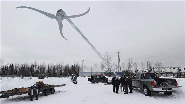  A screw lift slowly raises a 70-foot wind turbine into position at Begich Middle School in east Anchorage, Alaska on Monday, Feb. 27, 2012. The installation is part of the Alaska Wind for Schools program, a collaboration between the UAF Alaska Center for Energy and Power, the Renewable Energy Alaska Project, and the U.S. Dept. of Energy. 