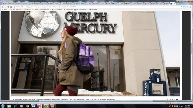 A woman walks by the Guelph Mercury office in Guelph, Ont. on Monday, Jan. 25, 2016 after almost 150 years. The Ontario city of over 100,000 is  now without it’s own daily paper.