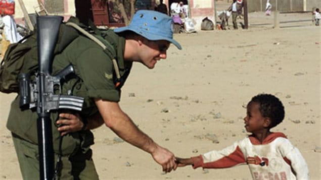 A Canadian soldier meets a young Eritrean during a familiarization patrol north of the Temporary Security Zone, as part of Operation Eclipse, Canada’s contribution to United Nations Mission in Ethiopia and Eritrea, 2001. Canada is creditied with creating UN peacekeeping and has participated in the vast majority of UN missions