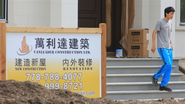 Chinese is the first language on a sign a mansion under construction in Vancouver.