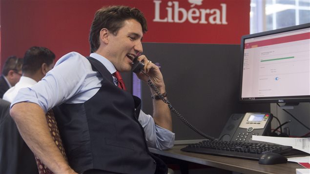 Prime Minister Justin Trudeau works the phones at Liberal headquarters in Ottawa, Wednesday October 19, 2016.