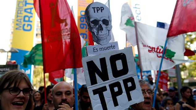 Activists shout slogans during a protest against the TPP (Trans-Pacific Partnership) and Monsanto Co, the world’s largest seed company at Santiago, Chile, January 22, 2016.