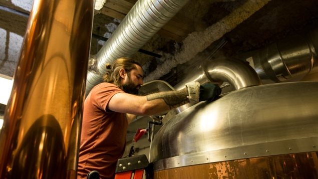Spike Baker checks on a batch of beer of Wood Buffalo Brewing Company in Fort McMurray.