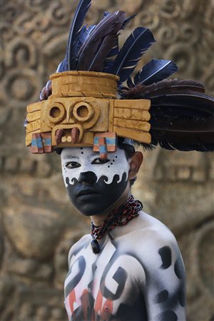 A man draws from his country’s history to prepare for Mexico’s Day of the Dead parade.