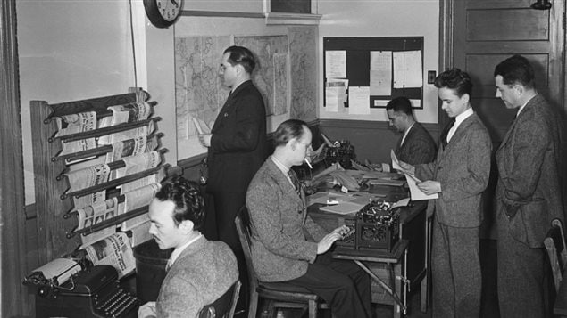 Journalists in the Radio-Canada newsroom in Montreal, July 1944. Smoking was common and acceptable in the workplace, but casual dress was not.