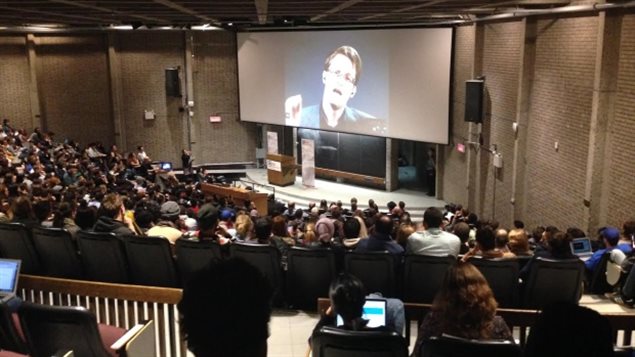 Edward Snowden told an overflow crowd of McGill students police action against journalists represents a threat to democracy.