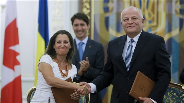Canadian International Trade Minister Chrystia Freeland shakes hands with Minister of Economic Development and Trade of Ukraine Stepan Kubiv during a signing ceremony in Kiev, Ukraine, Monday, July 11, 2016.