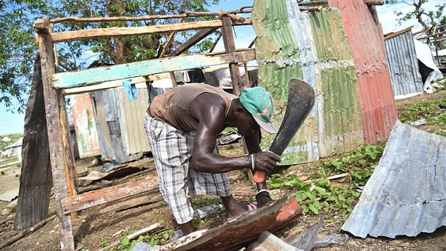 Venel Lague builds his shelter at a informal camp for people who lost their houses during the passage of the Hurricane Matthew, in the neighborhood of Gebeaux, in the commune of Jeremie, southwestern Haiti, on November 5, 2016.