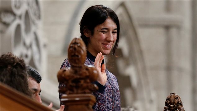 Nadia Murad Basee Taha, United Nations Goodwill Ambassador for the Dignity of Survivors of Human Trafficking, waves while being recognized by the Speaker in the House of Commons on Parliament Hill in Ottawa, Canada, October 25, 2016. 