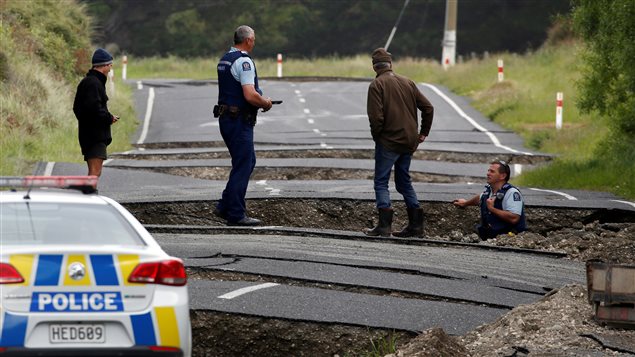 Policemen and locals look at damage following an earthquake, along State Highway One near the town of Ward, south of Blenheim on New Zealand’s South Island, November 14, 2016.