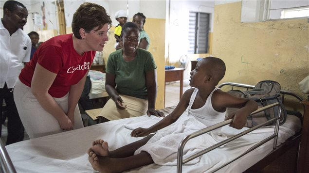 International Development Minister Marie-Claude Bibeau chats with a young patient at the Immaculate Conception Hospital, in Les Cayes, Haiti, on Thursday, November 17, 2016.