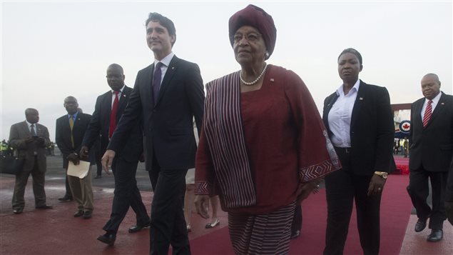 Canadian Prime Minister Justin Trudeau walks with Liberian President Ellen Johnson Sirleaf as he arrives in Monrovia, Liberia Thursday November 24, 2016. 