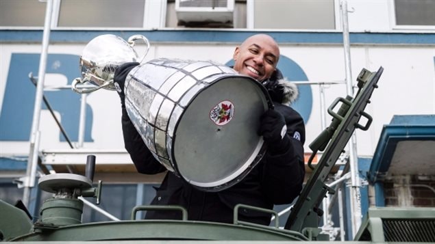 CFL commissioner Jeffrey Orridge and the Grey Cup arrive via armoured military vehilce to a ceremony on Toronto’s waterfront this week