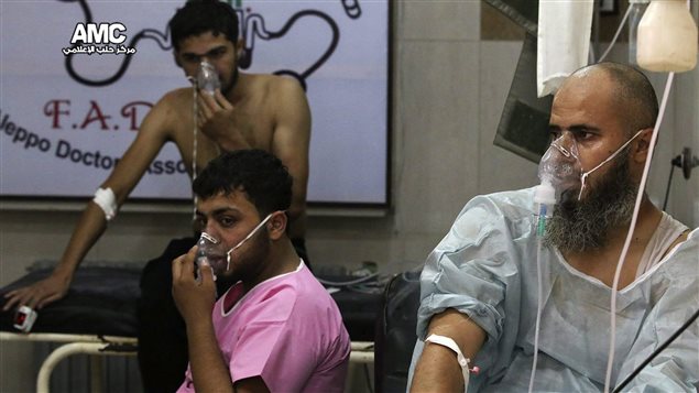 This Tuesday, Sept. 6, 2016 photo, provided by the Syrian anti-government activist group Aleppo Media Center (AMC), shows men breathing with oxygen masks inside a hospital in Aleppo, Syria. 