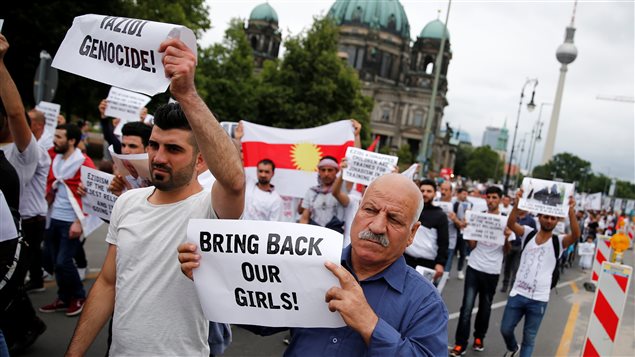 People attend a demonstration in Berlin to mark the second anniversary of the Sinjar massacre and what a U.N.-appointed commission of independent war crimes investigators termed a genocide against the Yazidi population by the Islamic State, Germany, August 3, 2016. 