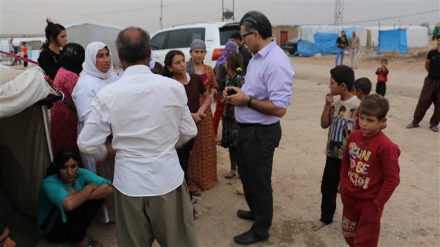 Dr. Jan Kizilhan (centre) talks to a group of Yazidi refugees in Northern Iraq.