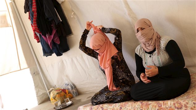 Yazidi sisters, who escaped from captivity by Islamic State (IS) militants, sit in a tent at Sharya refugee camp on the outskirts of Duhok province July 3, 2015. The sisters were among one hundred women, men and children taken by IS as prisoners after the militants attacked their village of Tal Ezayr in the northern Iraqi province of Mosul close to Syrian border in 2014.