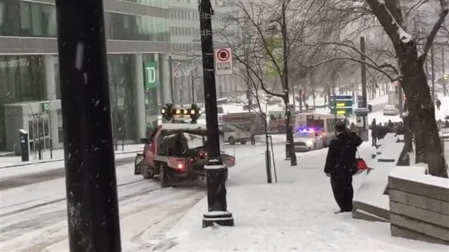 A public works sanding truck comes to the rescue..except..oh-oh, it’s now sliding too. (if only any of them had thought to get off the brakes and turn into the other lane where there was traction to stop.)