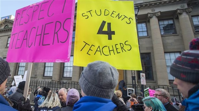 Students and parents protest outside the legislature in Halifax on Monday, Dec. 5, 2016. All Nova Scotia public schools are closed and the government plans to introduce legislation to end their contract dispute with teachers. 