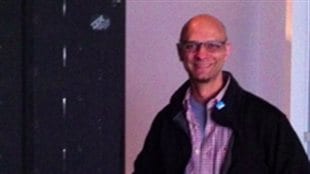 Professor Jim Davies (PhD) of Carleton University in front of IBM’s *Deep Blue*. the computer that beat world chessmaster Garry Kasparov in 1997. 