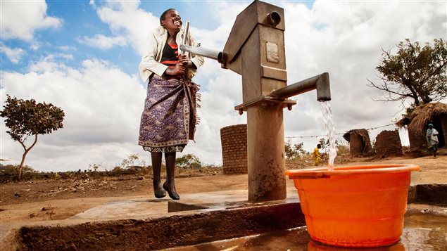 In Chikosa, Malawi, 12-year-old Kosalata Banda collects water from a recently installed water pump.