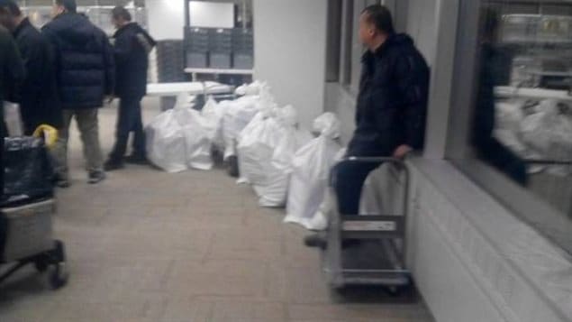 The Canadian Press reported that couriers arrived with bags of applications hours before the immigration centre opened in Mississauga, Ontario on Jan. 4, 2016.