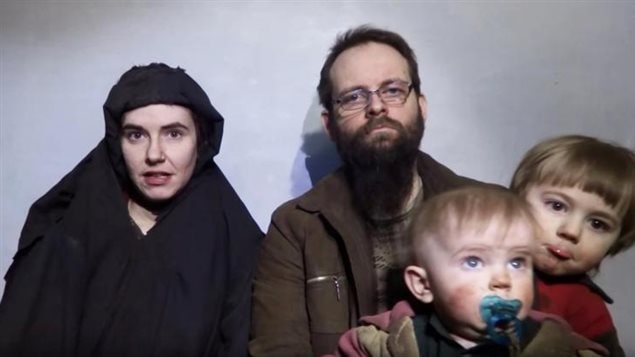A still image from a video posted by the Taliban on social media on December 19, 2016 shows American Caitlan Coleman (L) speaking next to her Canadian husband Joshua Boyle and their two sons.