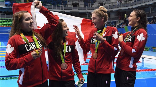 Brittany MacLean, Katerine Savard, Taylor Ruck, and Penny Oleksiak (left to right) celebrate after winning bronze in the women's 4 x 200-metre freestyle relay in Rio in August. The national women's swim team is The Canadian Press team of the year for 2016. 