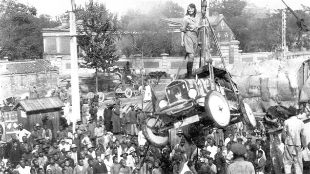 Osaka Japan, 1927. Aloha stands atop one of the cars as ii is loaded aboard ship. The stunt was a crowd pleaser and she would repeat it on other occasions