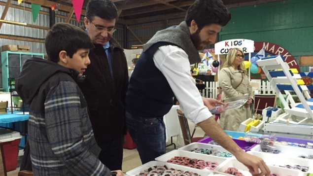 Tareq Hadhad (right) and his father and brother displaying their chocolates in the eastern city of Antigonish in 2016.