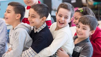 Syrian refugees Jamil Haddad, left, and Tony Batekh, 2nd left, George Louka and Edmon Artin, right, have some fun while they attend French classes at a school last February in Montreal. 