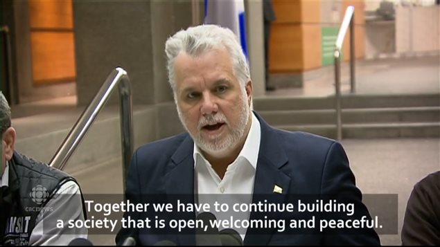 Quebec Premier Philippe Couillard speaking at a press conference immediately after learning of the shootings.