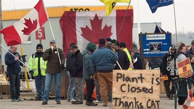 Some of the 450 Electro-Motive workers in London Ontario picketing after Caterpillar closed the locomotive plant in 2012 and moving the jobs to the US after Canadian workers refused the company demands for a 50 % wage cut after Caterpillar posted a $5 billion profit