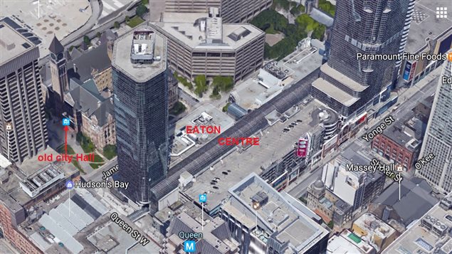 A recent aerial view showing the Eaton Centre and higly built up downtown with towers overshadowing *old City Hall* at left.